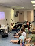 Musician Aaron Fowler came to the library with his a trained therapy dog on Thursday, June 20th to present his “The Adventure Begins Today!” Summer Reading program.