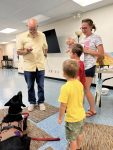 Musician Aaron Fowler came to the library with his a trained therapy dog on Thursday, June 20th to present his “The Adventure Begins Today!” Summer Reading program.